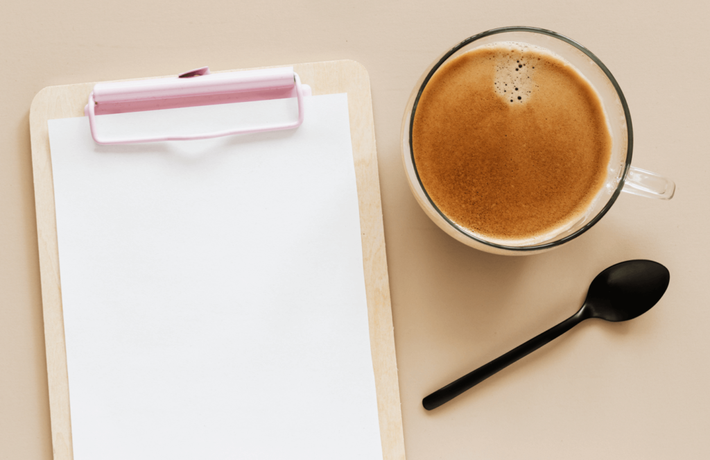 Espresso and a clipboard on a desk